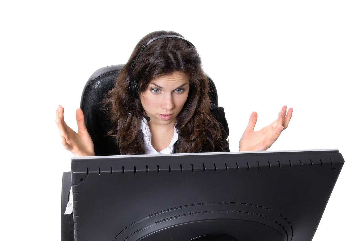Woman using her computer expressing frustration. 