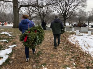 TCGer carrying Christmas wreaths away at Arlington National Cemetery.