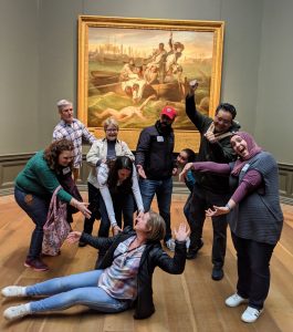 TCGers at the Museum Hack spree reenacting the event depicted in a painting on display.